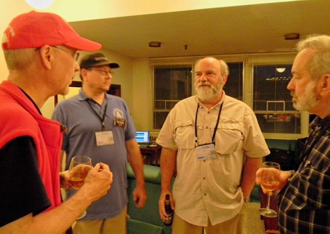 Text Box: L to R- Ken Redcap, Jerry Espada, Keith Payea and Jay Wilson enjoy refreshments and conversation in the Drake Lounge.