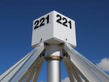 The enclosure at the top of each antenna houses two active baluns, one for each dipole, consisting of an amplifier for each antenna blade and a 180° hybrid junction to couple the coaxial feed.